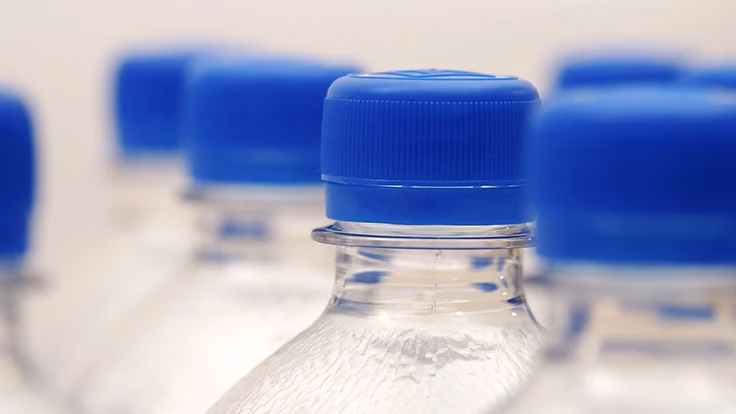 What is the weight of an empty plastic water bottle in grams?